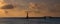 Silhouette shot of harbor entrance with lighthouse and bridge at sunrise time located in Montaza Park, Alexandria, Egypt