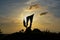 Silhouette shot of the statue of the deceased bikers under sunset yellow sky