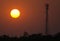 Silhouette signal antenna tower and the sun at sunset sky background