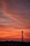 Silhouette signal antenna tower at sunrise sky