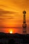 Silhouette signal antenna tower at sunset sky