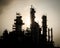 Silhouette of silent column tower in petrochemical plant