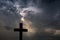 Silhouette of a simple catholic cross, dramatic stormclouds