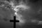 Silhouette of a simple catholic cross, dramatic stormclouds after heavy rain