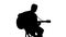 Silhouette of sitting man playing the guitar on a