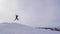 Silhouette of skier jumping on mountain ski slope.