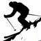 Silhouette of skier on steep mountain slope