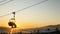 Silhouette skiers climbing up by the chair lift in sunrise