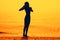 Silhouette of a skinny young girl walking along the beach