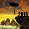 Silhouette skydiver parachutist landing in to the New Year 2016