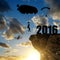 Silhouette skydiver parachutist landing in to the New Year 2016