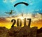 Silhouette skydiver parachutist landing in to the New Year 2017