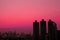 Silhouette of skyscrapers Against Evening Sky in Vibrant Pink Gradation