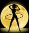 Silhouette of a slender woman doing exercises with hula-hoop