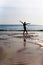 Silhouette of a slim girl against the background of the sea