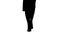 Silhouette Slim legs of woman wearing high heel shoes walking.