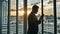 Silhouette Slow motion Businessman Standing With Smartphone By Window In The Office