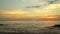 A silhouette of the small boat with the fisherman at sunset. Boat on open sea sunset horizon.