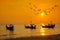 Silhouette Small fishing boat with birds and sunsets