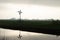 Silhouette of a small windmill in an agricultural setting used to drain the land in wetlands, the polder landscape in the