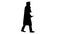Silhouette Smiling male student in graduation robe walking and m