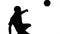 Silhouette of soccer player kicking ball