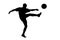 A silhouette of a soccer player shooting a ball