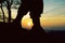 Silhouette of soldier boots on mountain at sunset