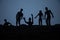 Silhouette some zombies on the cemetery walking around at sunset. Selective focus