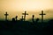 Silhouette some zombies on the cemetery walking around at sunset. Selective focus