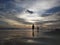 A silhouette of someone on the edge of Parangtritis beach watching the sunset