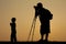 The silhouette of the son and father Stand to take pictures in the morning atmosphere