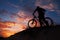 Silhouette of sports person cycling on the meadow