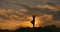 Silhouette of sporty man standing at yoga pose outdoor. Yogi practicing yoga moves and positions in nature. Athlete