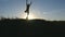 Silhouette of sporty man standing at yoga pose outdoor. Yogi practicing yoga moves and positions in nature. Athlete