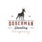 Silhouette of a standing doberman dog with retro vintage style logo design