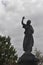 Silhouette Statue of an Angel Pointing Up to the Sky in a Cemetery