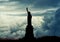 Silhouette of Statue of Liberty over dramatic full moon, New York, USA