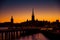 Silhouette of Stockholm cityscape skyline with Riddarholmen Church spires, City Hall Stadshuset tower, bridge over Lake Malaren in