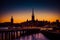 Silhouette of Stockholm cityscape skyline with Riddarholmen Church spires, City Hall Stadshuset tower, bridge over Lake Malaren in