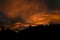 Silhouette of street of houses exterior in sunset with dark sky behind buildings