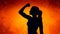 Silhouette of strong empowered woman on orange background