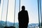 Silhouette of a successful businessman in suit is thinking about future of his company