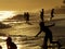 Silhouette summer people having fun at the beach sunset