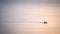 Silhouette sunrise of minimal fishery boat sail on calm sea