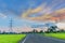 Silhouette the sunrise with the road, green paddy rice field, the beautiful sky and cloud in Thailand, by the beam, light and lens