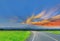 Silhouette the sunrise with the road, green paddy rice field, the beautiful sky and cloud, Thailand fuji mountain, by the beam,