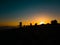 Silhouette of surf photographers on beach at sunset