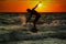 Silhouette of surfer at sunset