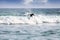 Silhouette of a surfer on waves on famous beach in Sri Lanka.